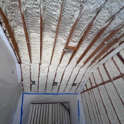 Interior wall soundproofing using open-cell spray foam for sound mitigation.