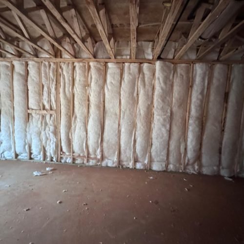 Professional sound mitigation insulation installed in interior walls to reduce noise transfer between rooms.