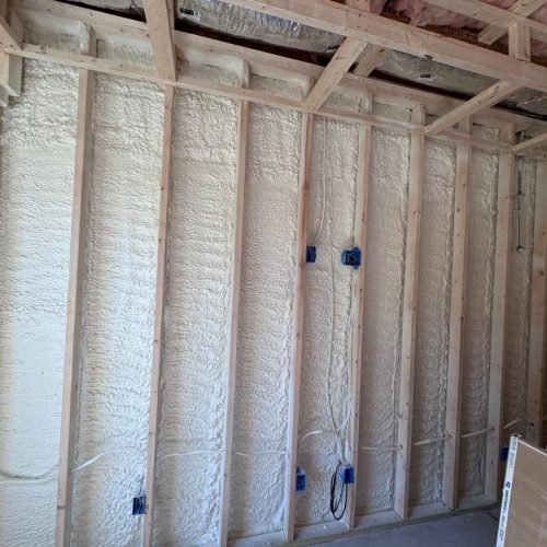 Professional sound mitigation insulation installed in interior walls to reduce noise transfer between rooms.