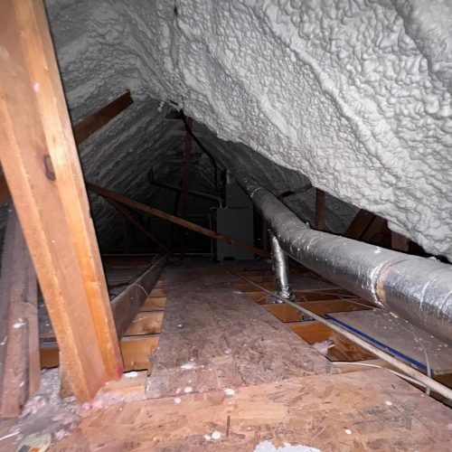 Precision blown-in insulation reaches tight corners and irregular spaces in residential attics.