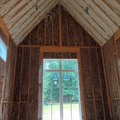 Precision spray foam application around window frames to eliminate air leaks and drafts.