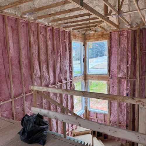 Professional fiberglass batt insulation installed in residential wall cavities by Brother's Foam Solution in Georgia.
