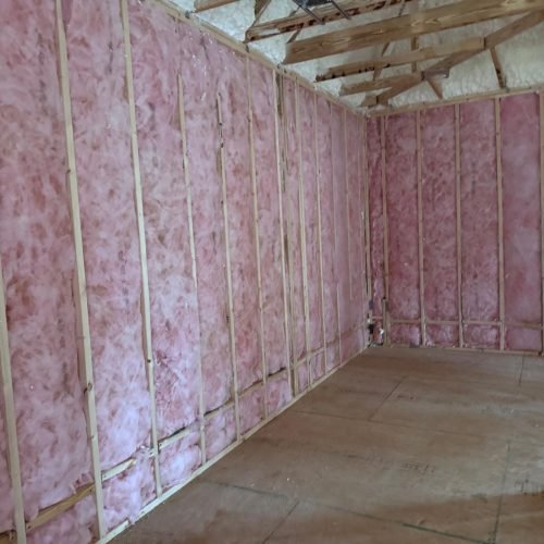 Professional fiberglass batt insulation installed in residential wall cavities by Brother's Foam Solution in Georgia.