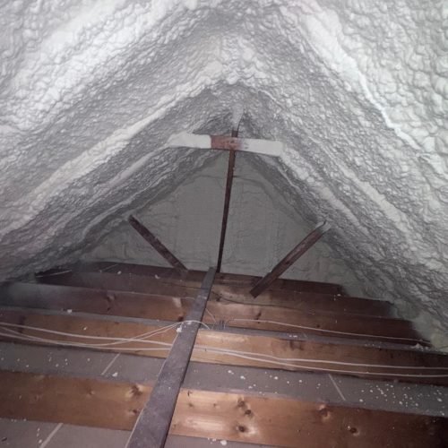 Seamless blanket of high-density blown-in insulation covering attic floor joists in a Georgia home.