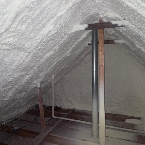 Precision blown-in insulation reaches tight corners and irregular spaces in residential attics.