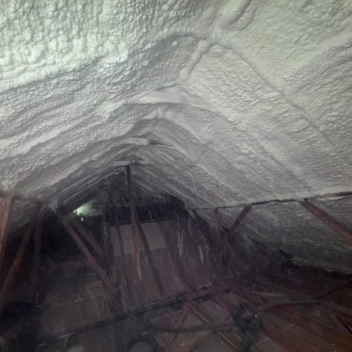 Precision blown-in insulation reaches tight corners and irregular spaces in residential attics.