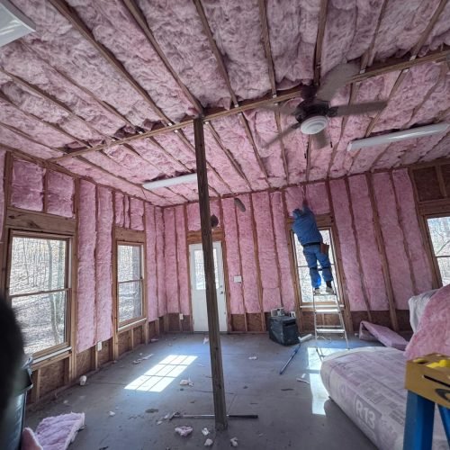 Professional fiberglass batt insulation installed in residential wall cavities by Brother's Foam Solution in Georgia.