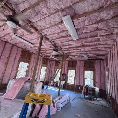 Professional fiberglass batt insulation installed in residential wall cavities by Brother's Foam Solution in Georgia.