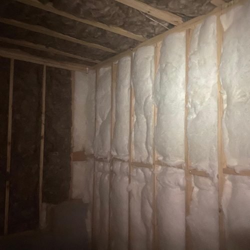 Professional fiberglass batt insulation installed in residential wall cavities by Brother's Foam Solution in Georgia.