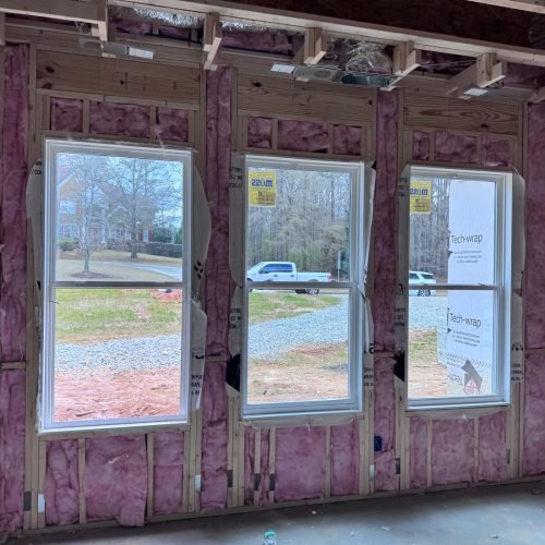 Professional fiberglass batt insulation installed in residential wall cavities by Brother's Foam Solution in Georgia.